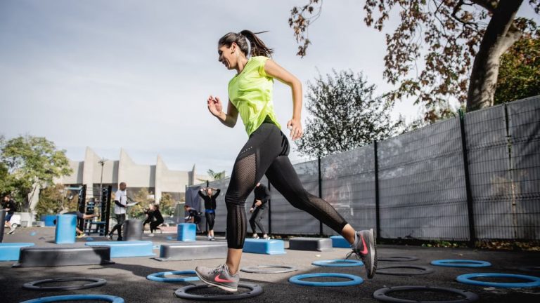 Young woman performing agility exercises outdoors in Boulogne, IDF, France.